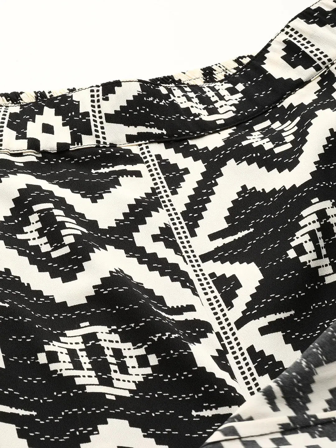 Overlap tie up crop top with flare pants in Black and Cream Ikkat Print Fleece Nylon Spandex Overlap tie up crop top with flare pants in Black and Cream Ikkat Print Fleece Nylon Spandex